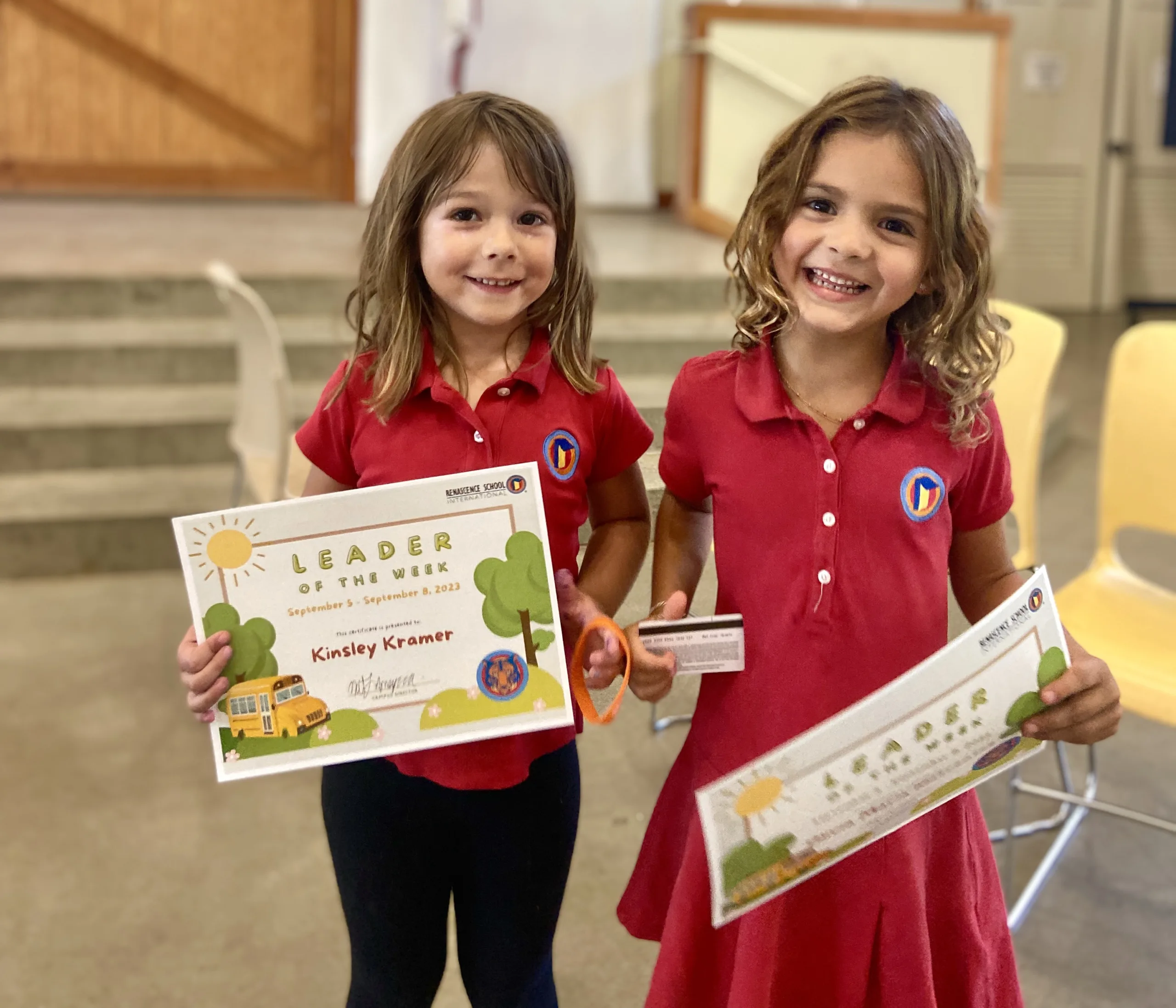 two-girls-holding-certificates