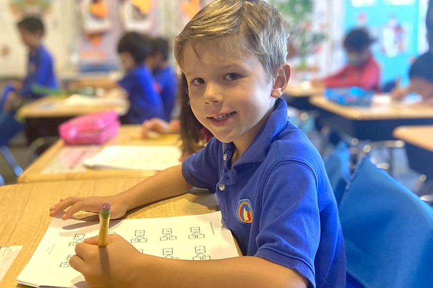 boy-in-school-uniform-holding-pencil