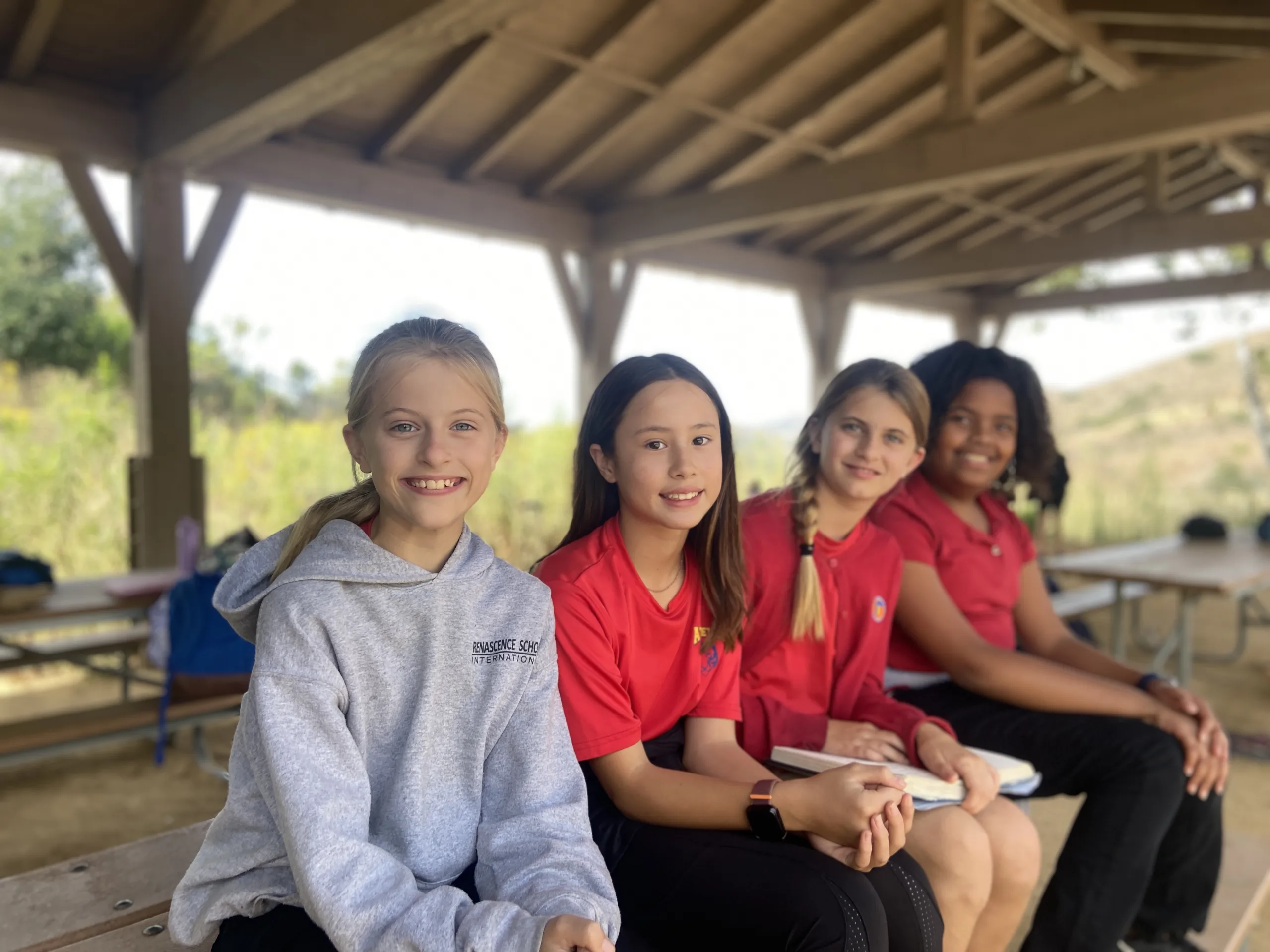 students-sitting-on-table-outside