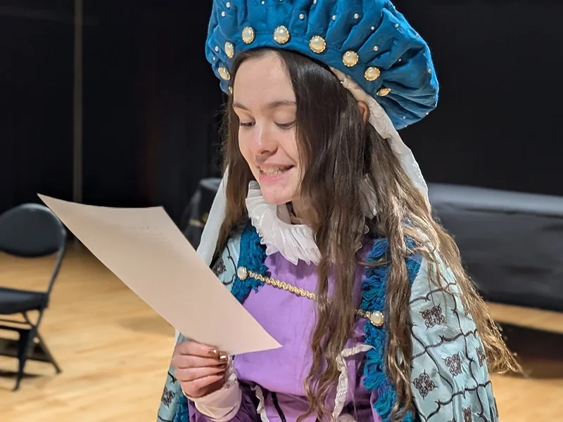 girl-in-costume-reviewing-paper